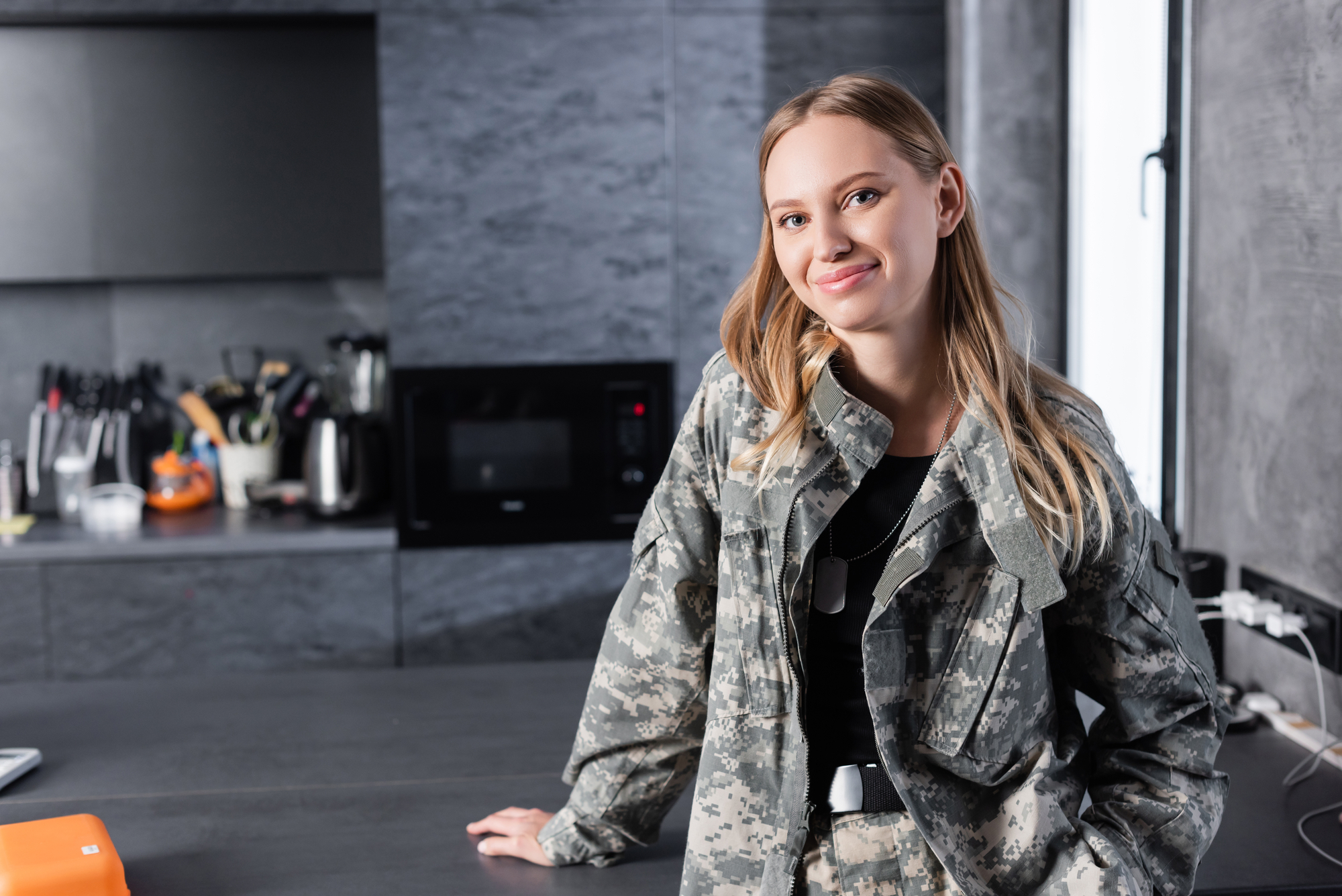 smiling military woman in the kitchen